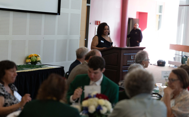 Seferine Baez at podium at Gold Key Breakfast in main lounge.