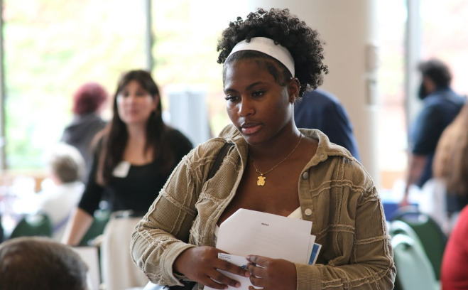 Female student at career fair in main lounge.