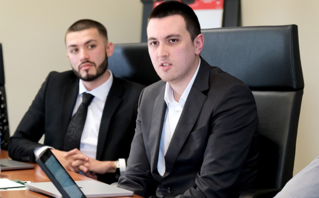 Professional business students at conference table.