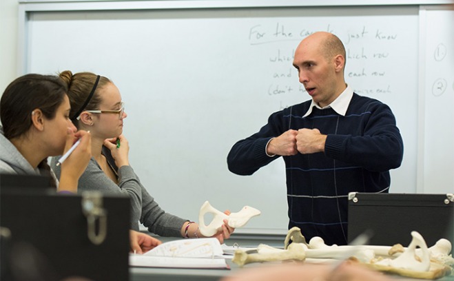 Photo of students and a professor in a Biology and Chemistry classroom