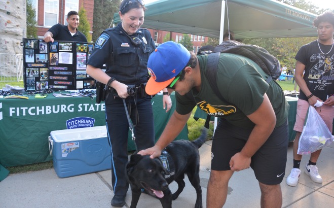 Photo of police dog Odin greeting students with Officer Erin Morreale