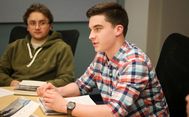 Male Students in English Honors Class discussing book