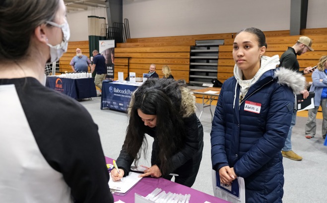 Female students at a table at the career fair in rec center