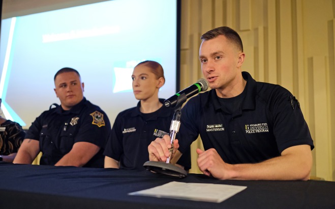 Two male and one female criminal justice students talking at future falcon day