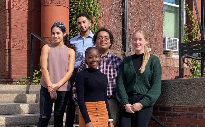 3 Female and 2 Male TRIO  Student Support Squad Leaders on steps outside of Thompson