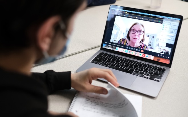 ALFA student mentor on laptop screen with undergraduate writing student