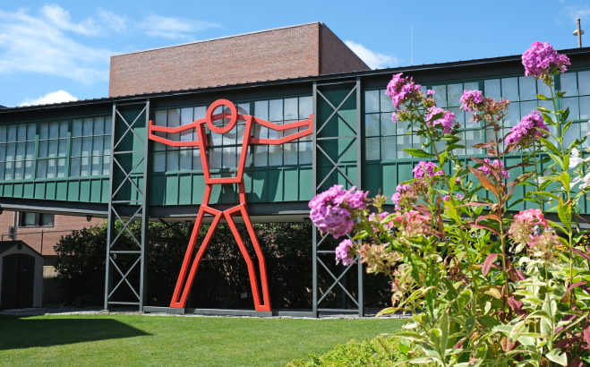 Fitchburg Art Museum outside building with big red man and flowers