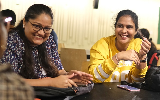 Female international students laughing in falcon hub