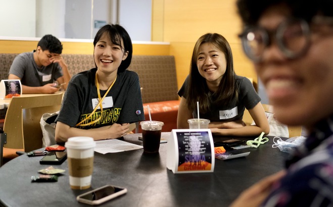 International female students smiling at orientation in Falcon Hub