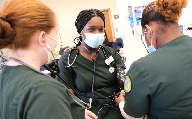 Nursing student taking blood pressure