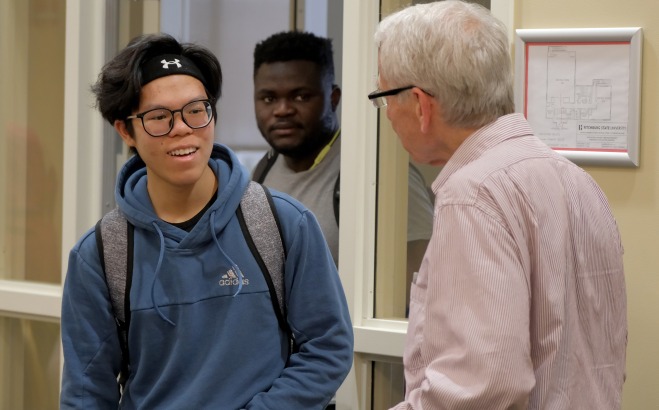 Math Honor Society Meeting professor talking to two male students