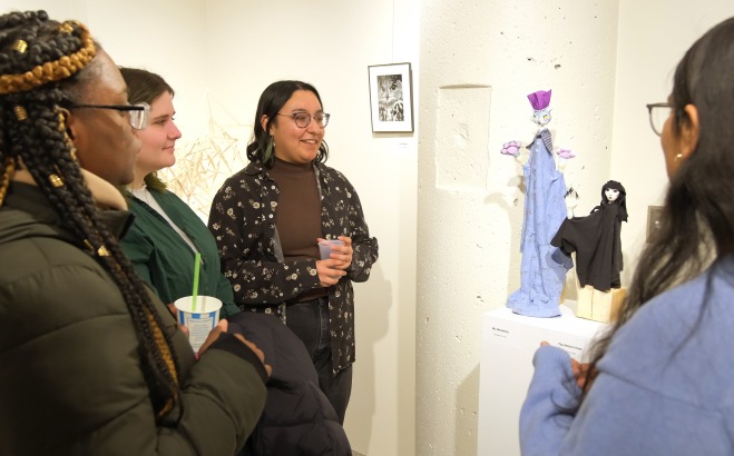 Female students in art gallery admiring sculptures during Arteries