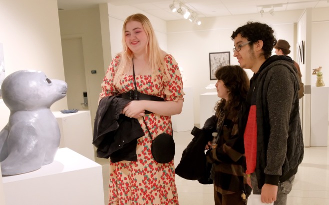 Students admiring seal sculpture in gallery at Arteries