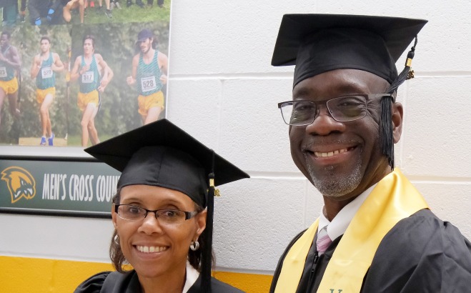 Male and female grad students before commencement