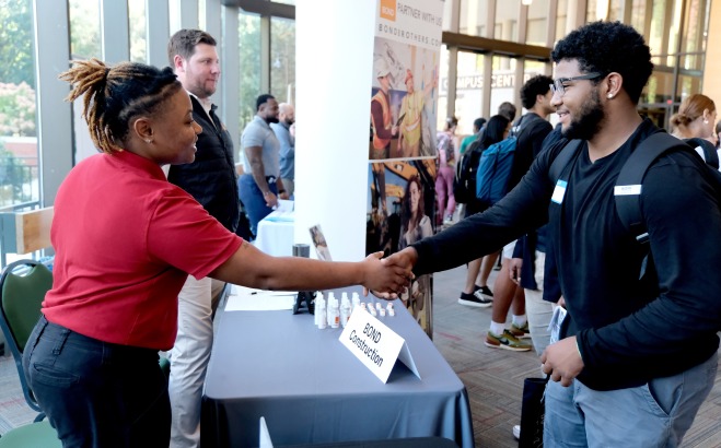 Internship Fair student and employers shaking hands