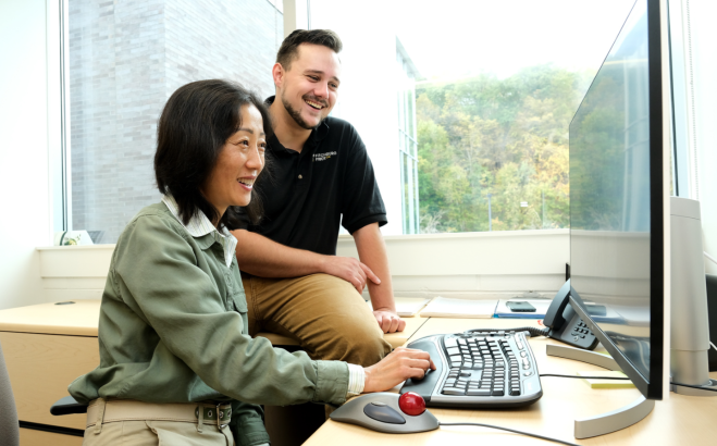 Jane Huang and alum Tristan Taylor at computer