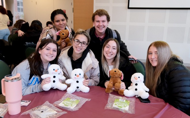 Students posing at table in main lounge