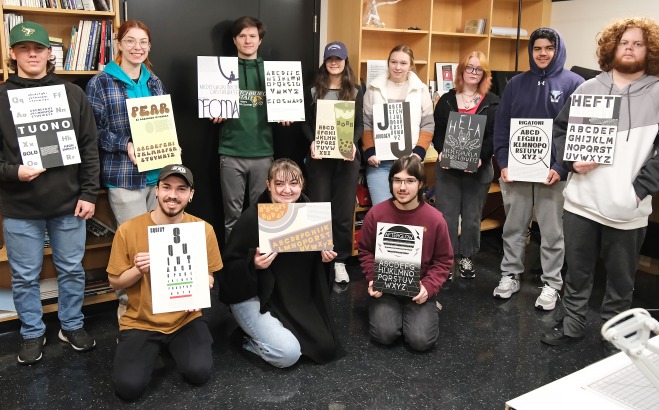 Group of font design students with their projects