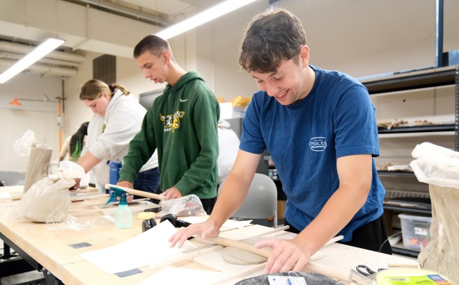 Students working with clay in ceramics class