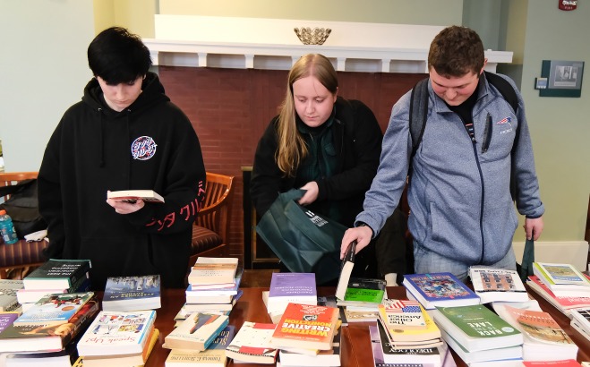 Students looking at books in Miller Hall