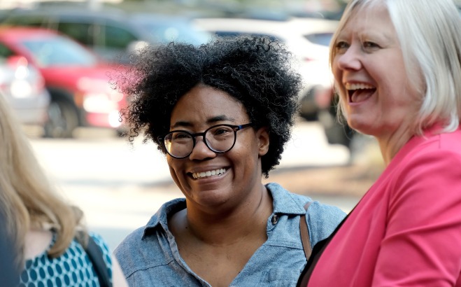 Smiling DeMisty and laughing Hildy outside