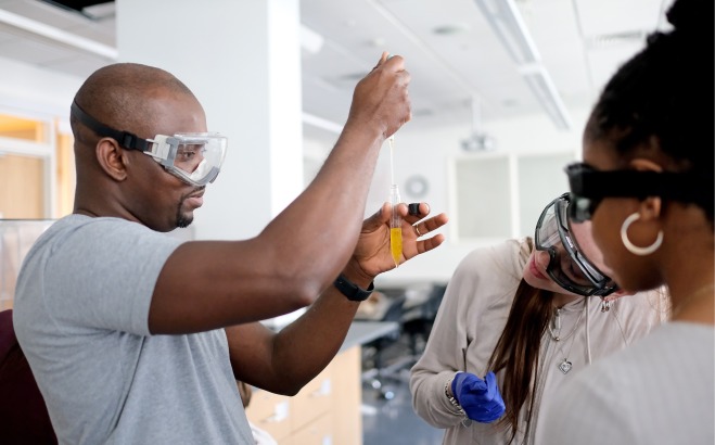 Student putting chemicals in test tube