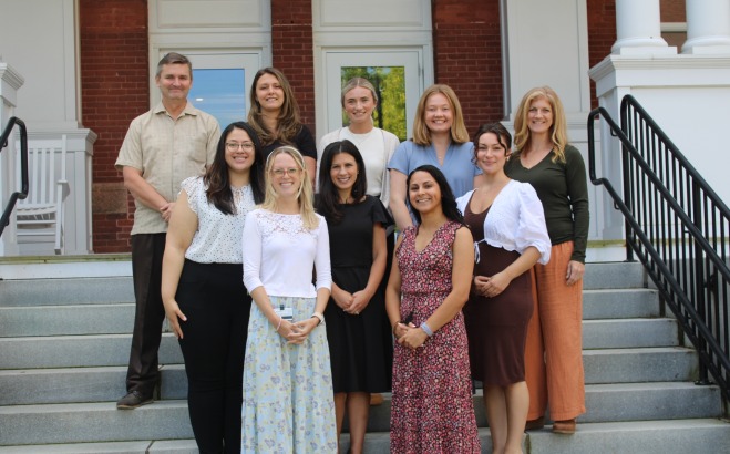 Group photo of the counseling services staff on steps of Thompson Hall