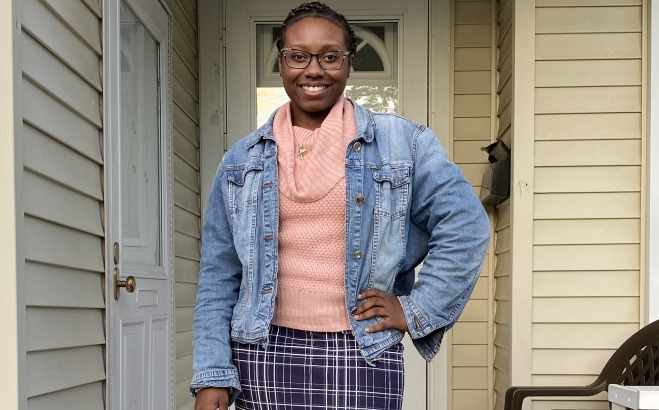 Mica Mclaurin ACT full length standing in front of door