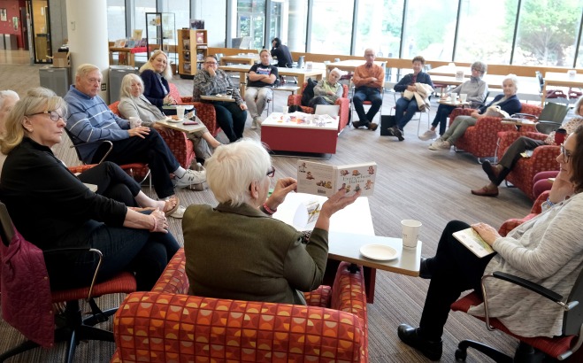 Members of ALFA, staff, faculty discussing banned books in main lounge