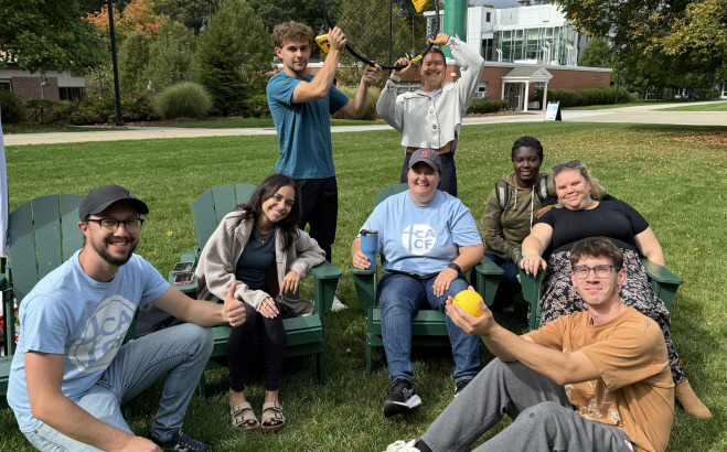 Group of students sitting on the quad with games.