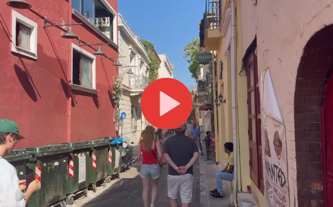 Play button over pic of students walking down street in Greece