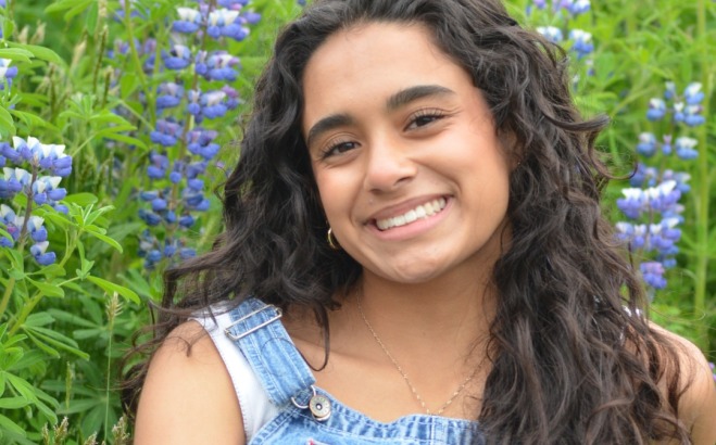 Ava Robles ACT Tutor sitting outside in flowers
