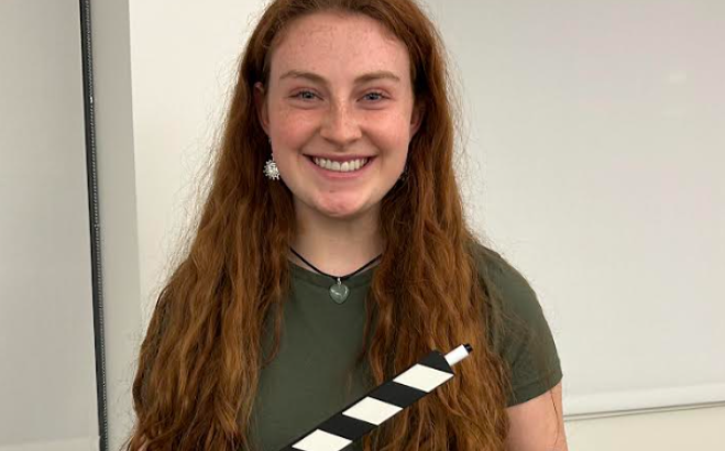 Cassandra Israelson ACT holding a clapboard