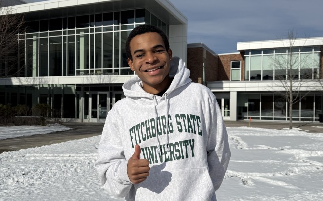 Christian Dedier on quad in the snow with sweatshirt giving thumbs up