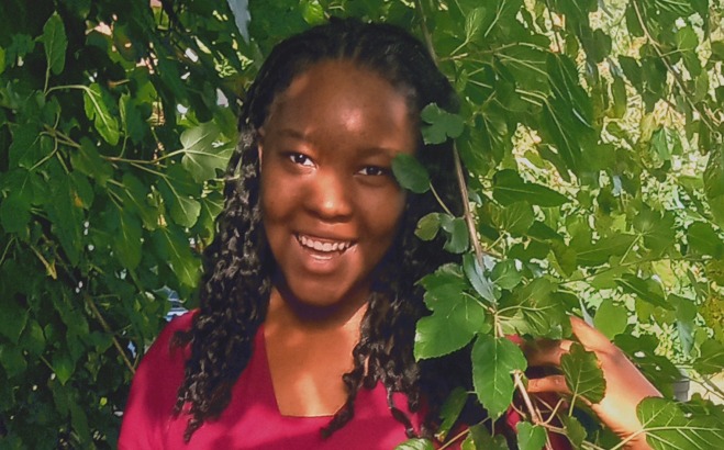Elischama Rene ACT Tutor outside in a bush