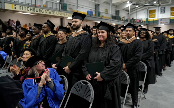 Grad students standing in rec center at commencement
