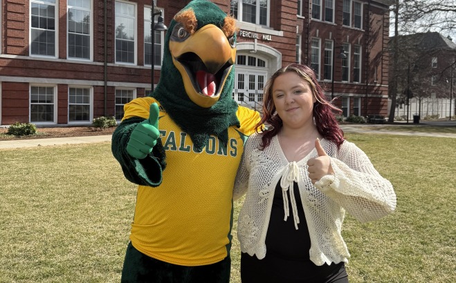 Keirsten Anderson with Freddy on the quad giving thumbs up