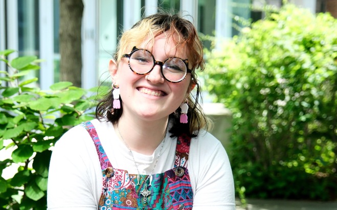 Photo of Autumn Hughes sitting outside.