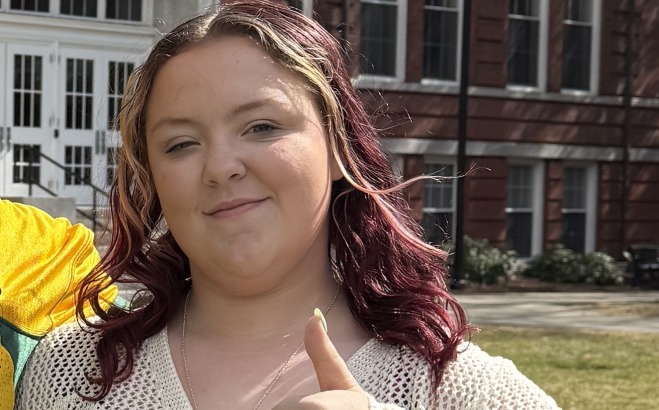 Keirsten Anderson on the quad giving thumbs up.