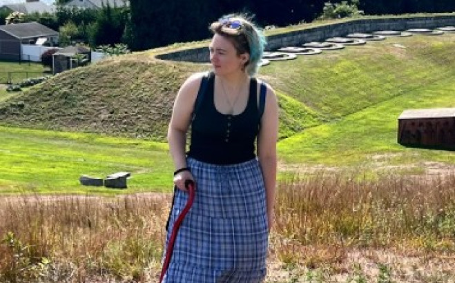 Ash Pierce outside in field.