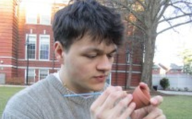 Felix Navarrete ACT tutor outside on quad doing crafts.