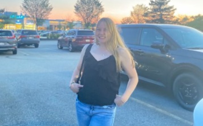 Lauren Ahearn ACT athlete tutor outside in a parking lot.