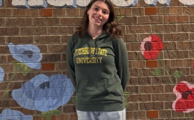 Lexi Sandmann outside against a flower wall.