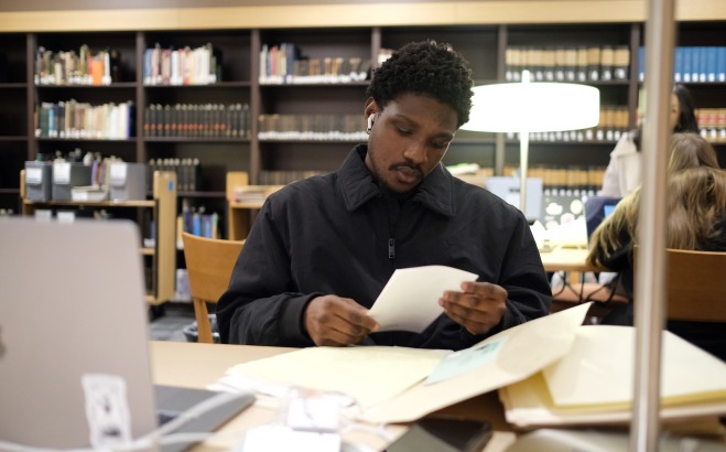 Male student doing research in the archives