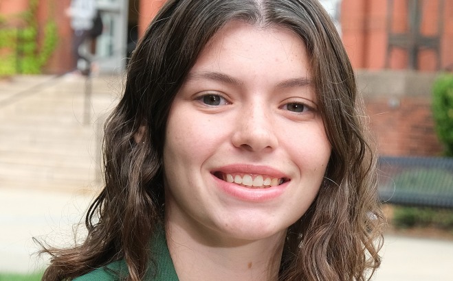 Lexi Sandmann headshot outside in front of Thompson Hall. 