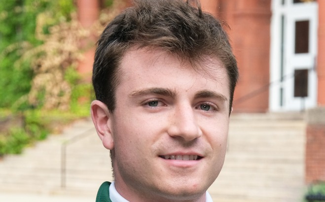 PJ Norton headshot outside in front of Thompson Hall. 