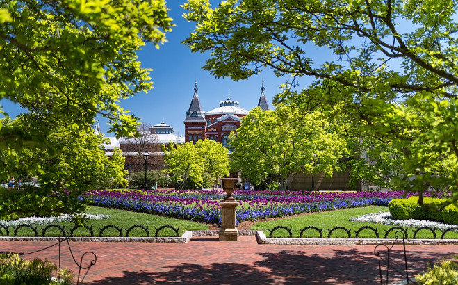 Arts and Industries Building in DC behind a flower garden.