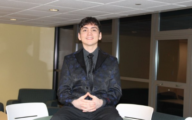 Adrian Barzola sitting on table. 