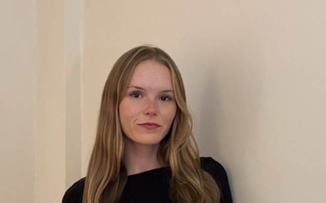 Amanda Bowe ACT standing against a wall.