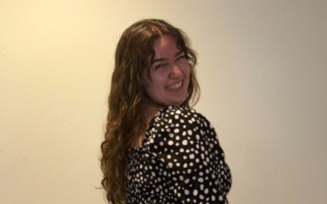 Madeline Curran ACT Tutor posing against a wall.